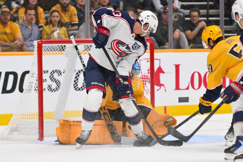 Oct 9, 2025; Nashville, Tennessee, USA; Nashville Predators goaltender Juuse Saros (74) blocks the deflection of Columbus Blue Jackets center Sean Monahan (23) during the first period at Bridgestone Arena. Mandatory Credit: Steve Roberts-Imagn Images