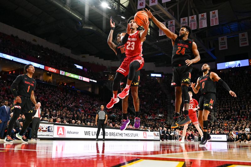 Jan 25, 2023; College Park, Maryland, USA;  Wisconsin Badgers guard Chucky Hepburn (23) shoots a as Maryland Terrapins forward Donta Scott (24) defends during the first half at Xfinity Center. Mandatory Credit: Tommy Gilligan-USA TODAY Sports