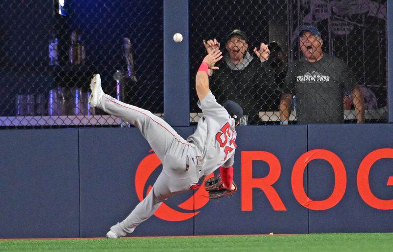 May 1, 2025; Toronto, Ontario, CAN; Boston Red Sox right fielder Wilyer Abreu (52) fails to catch a ball hit for a double by Toronto Blue Jay shortstop Bo Bichette (not shown) in the eighth inning at Rogers Centre. Mandatory Credit: Dan Hamilton-Imagn Images