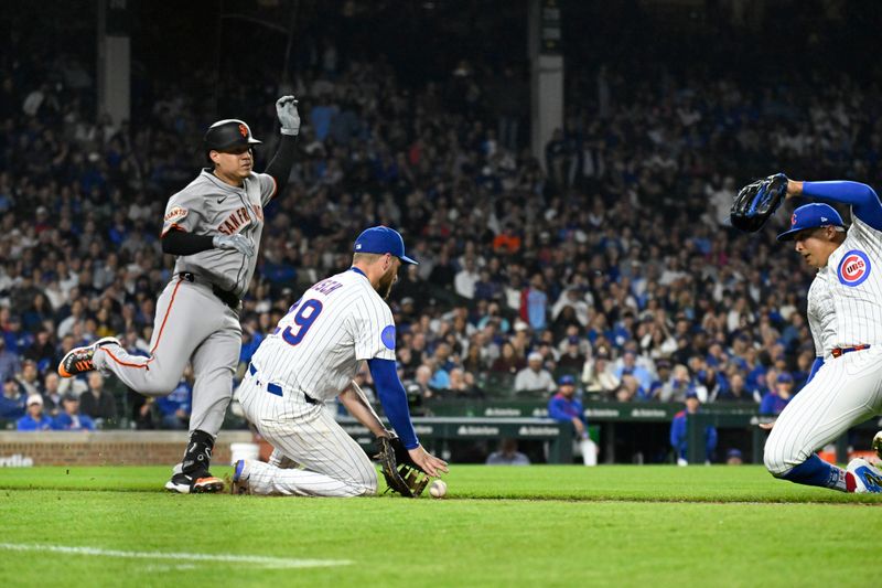 May 6, 2025; Chicago, Illinois, USA;  San Francisco Giants first base Wilmer Flores (41) runs between Chicago Cubs pitcher Daniel Palencia (48) and first baseman Michael Busch (29) during the eighth inning at Wrigley Field. Mandatory Credit: Matt Marton-Imagn Images
