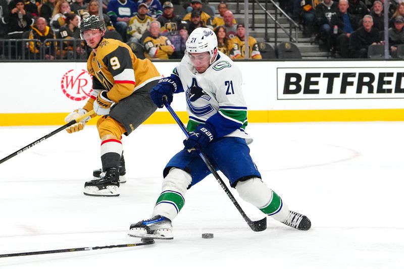 Mar 7, 2024; Las Vegas, Nevada, USA; Vancouver Canucks left wing Nils Hoglander (21) is tripped by the stick of Vegas Golden Knights defenseman Brayden McNabb (3) during the first period at T-Mobile Arena. Mandatory Credit: Stephen R. Sylvanie-USA TODAY Sports