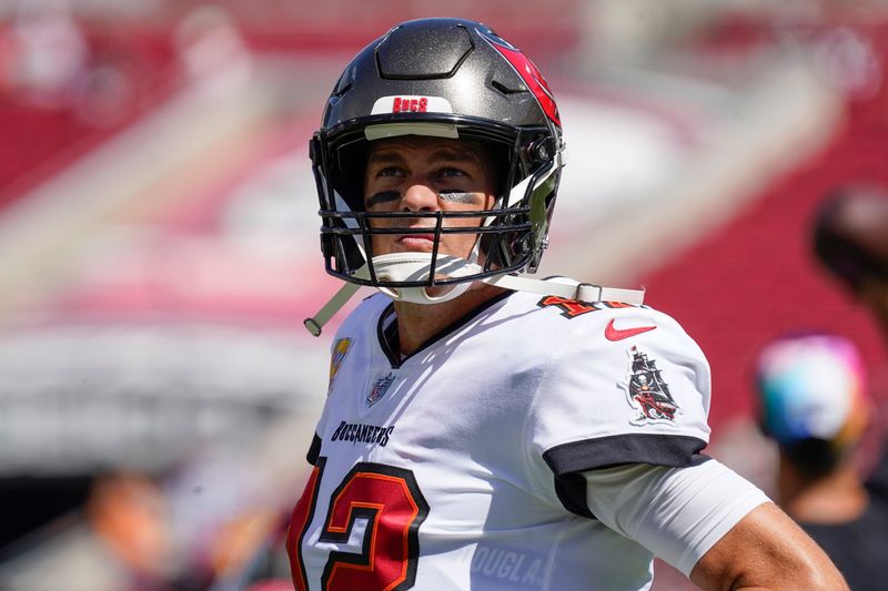 Tampa Bay Buccaneers quarterback Tom Brady warms up before the first half of an NFL football game between the Tampa Bay Buccaneers and the Atlanta Falcons Sunday, Oct. 9, 2022, in Tampa, Fla. (AP Photo/Chris O'Meara)