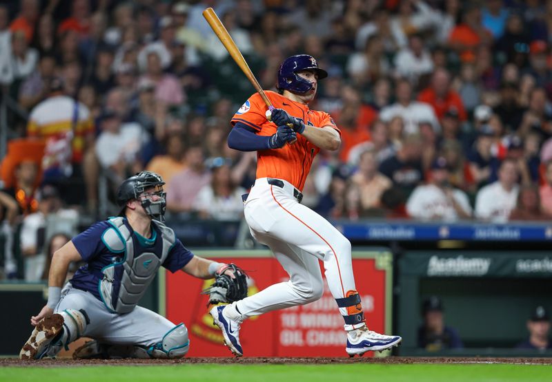 May 3, 2024; Houston, Texas, USA; Houston Astros left fielder Joey Loperfido (10) hits a single during the third inning against the Seattle Mariners at Minute Maid Park. Mandatory Credit: Troy Taormina-USA TODAY Sports