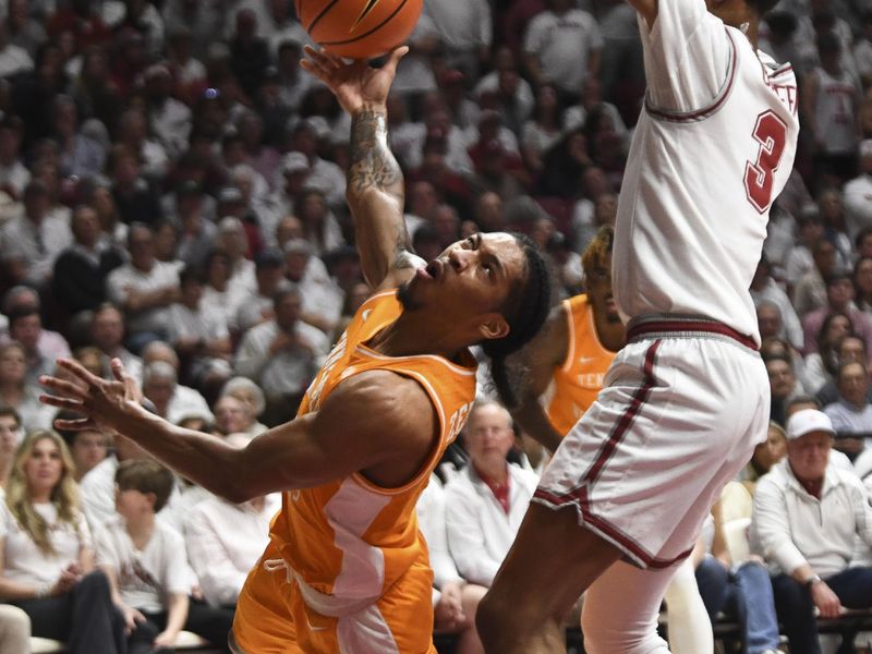 Mar 2, 2024; Tuscaloosa, Alabama, USA;  Tennessee guard Zakai Zeigler (5) loses his balance as he attempts a shot against Alabama guard Rylan Griffen (3) at Coleman Coliseum. Mandatory Credit: Gary Cosby Jr.-USA TODAY Sports