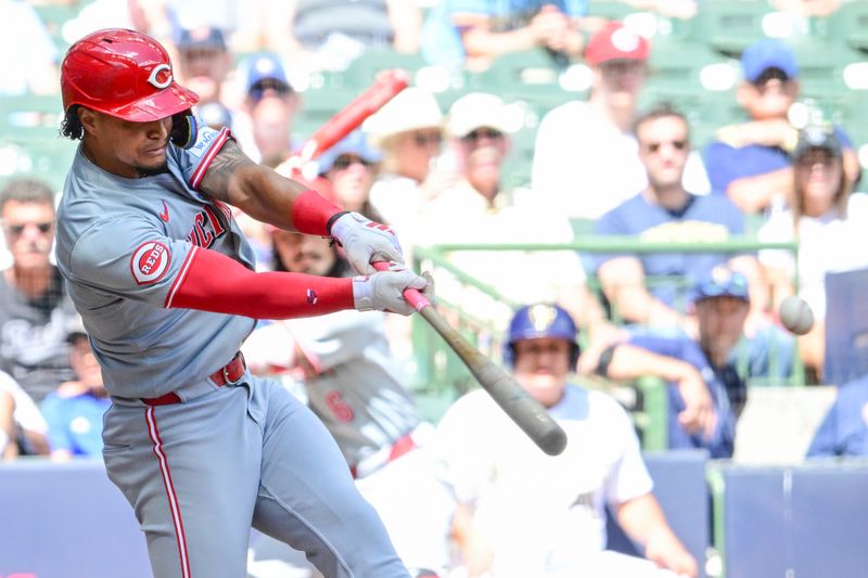 Aug 11, 2024; Milwaukee, Wisconsin, USA; Cincinnati Reds second baseman Santiago Espinal (4) hits a single to drive in two runs in the fourth inning against the Milwaukee Brewers at American Family Field. Mandatory Credit: Benny Sieu-USA TODAY Sports