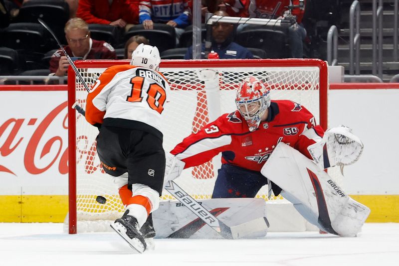 Sep 22, 2024; Washington, District of Columbia, USA; Philadelphia Flyers forward Bobby Brink (10) scores a goal on Washington Capitals goaltender Clay Stevenson (33) in a shootout at Capital One Arena. Mandatory Credit: Geoff Burke-Imagn Images