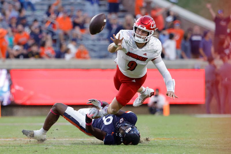 Oct 12, 2024; Charlottesville, Virginia, USA; Louisville Cardinals quarterback Tyler Shough (9) throws the ball as Virginia Cavaliers cornerback Jam Jackson (9) defends during the second half at Scott Stadium. Mandatory Credit: Amber Searls-Imagn Images