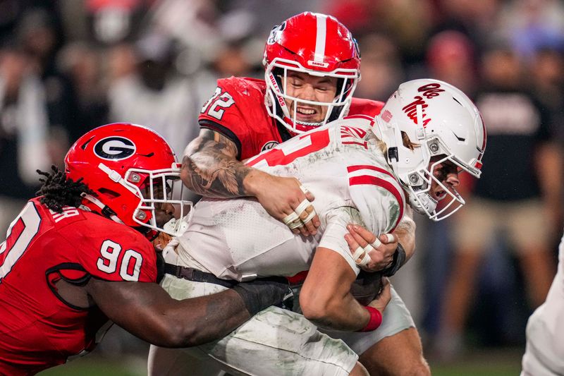 Nov 11, 2023; Athens, Georgia, USA; Georgia Bulldogs defensive lineman Tramel Walthour (90) and linebacker Chaz Chambliss (32) tackle Mississippi Rebels quarterback Jaxson Dart (2) during the first half at Sanford Stadium. Mandatory Credit: Dale Zanine-USA TODAY Sports