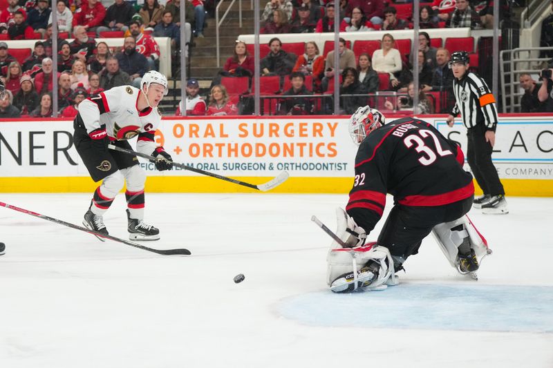 Feb 3, 2026; Raleigh, North Carolina, USA;  Carolina Hurricanes goaltender Brandon Bussi (32) stops the shot by Ottawa Senators left wing Brady Tkachuk (7) during the second period at Lenovo Center. Mandatory Credit: James Guillory-Imagn Images