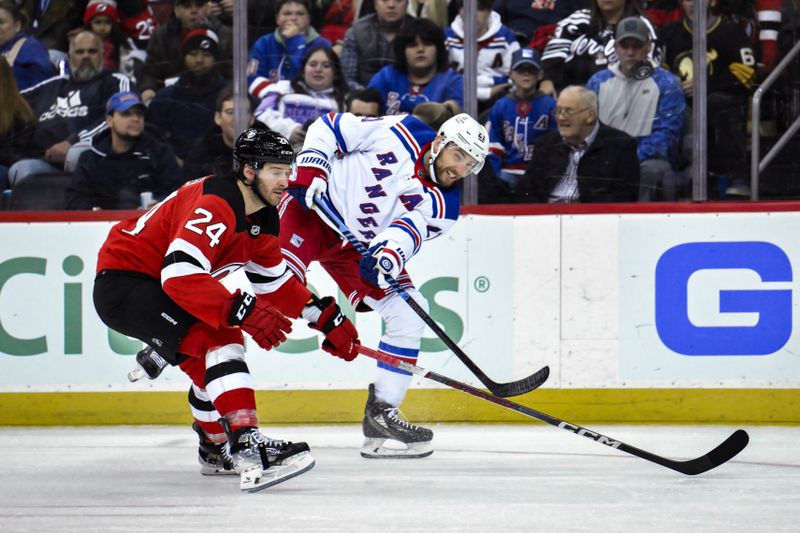 sNov 18, 2023; Newark, New Jersey, USA; New York Rangers center Barclay Goodrow (21) shoots the puck against New Jersey Devils defenseman Colin Miller (24) during the third period at Prudential Center. Mandatory Credit: John Jones-USA TODAY Sports