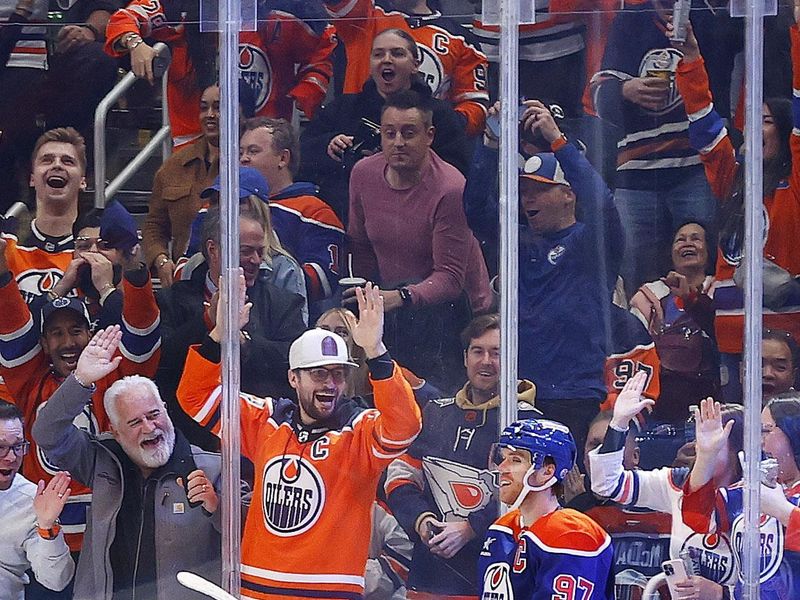 Nov 14, 2024; Edmonton, Alberta, CAN; Edmonton Oilers forward Connor McDavid (97) celebrates after scoring a goal during the second period, his 1000th NHL point against the Nashville Predators at Rogers Place. Mandatory Credit: Perry Nelson-Imagn Images