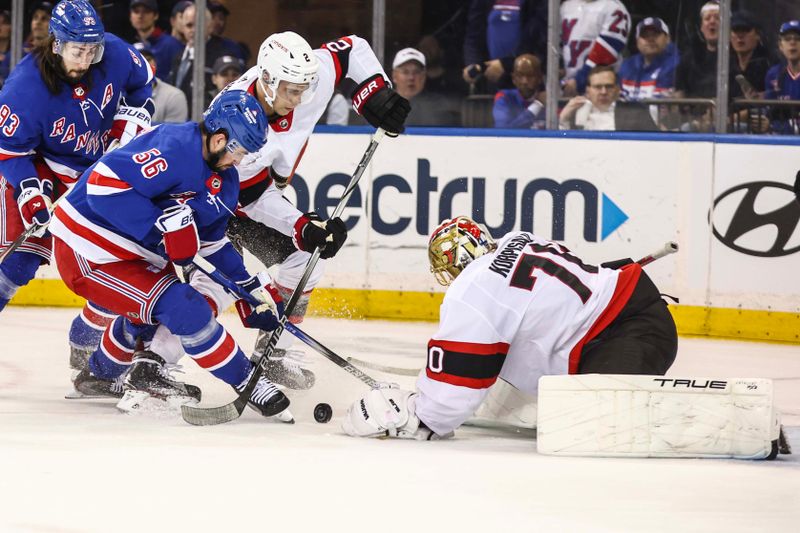 Apr 15, 2024; New York, New York, USA;  Ottawa Senators goaltender Joonas Korpisalo (70) defends the net from a shot on goal attempt by New York Rangers defenseman Erik Gustafsson (56) in the first period at Madison Square Garden. Mandatory Credit: Wendell Cruz-USA TODAY Sports