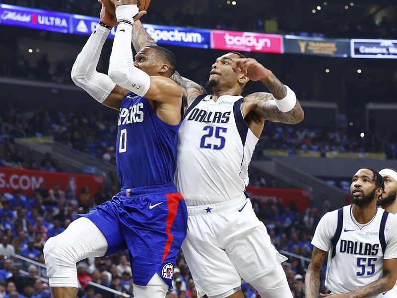 LOS ANGELES, CALIFORNIA - APRIL 21:  Russell Westbrook #0 of the LA Clippers is fouled by P.J. Washington #25 of the Dallas Mavericks in the first half during game one of the Western Conference First Round Playoffs at Crypto.com Arena on April 21, 2024 in Los Angeles, California.   NOTE TO USER: User expressly acknowledges and agrees that, by downloading and/or using this photograph, user is consenting to the terms and conditions of the Getty Images License Agreement.  (Photo by Ronald Martinez/Getty Images)