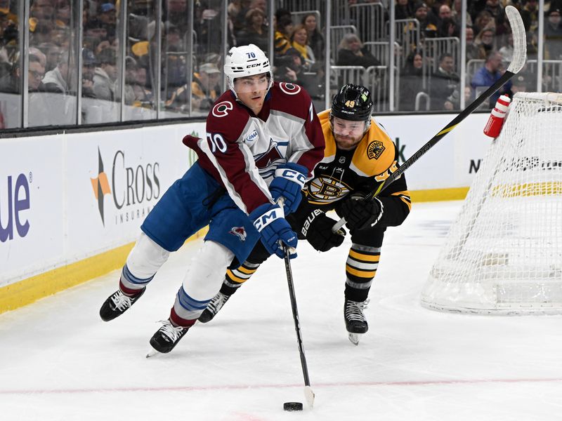 Jan 25, 2025; Boston, Massachusetts, USA; Colorado Avalanche defenseman Sam Malinski (70) skates with the puck against Boston Bruins left wing Max Jones (49) during the first period at the TD Garden. Mandatory Credit: Brian Fluharty-Imagn Images