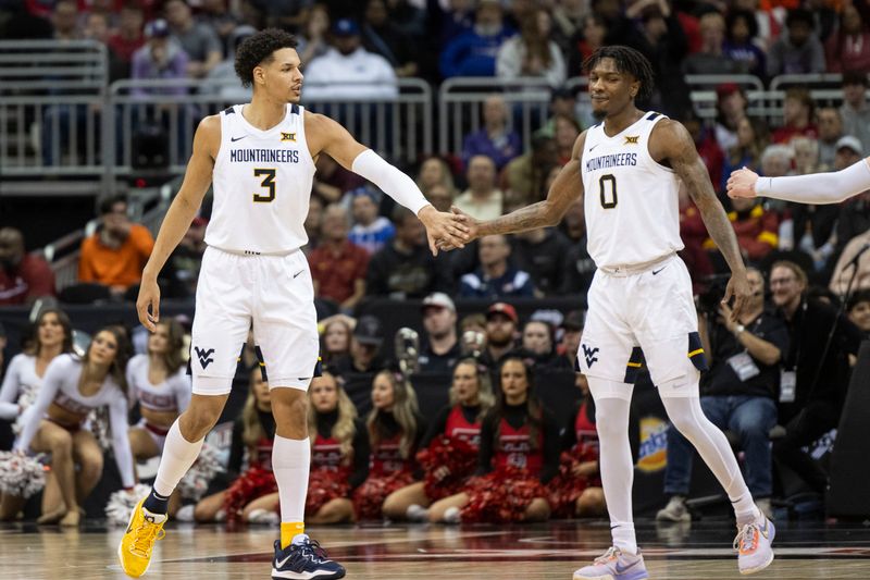 Mar 8, 2023; Kansas City, MO, USA; West Virginia Mountaineers forward Tre Mitchell (3) reacts with guard Kedrian Johnson (0) in the second half against the Texas Tech Red Raiders at T-Mobile Center. Mandatory Credit: Amy Kontras-USA TODAY Sports