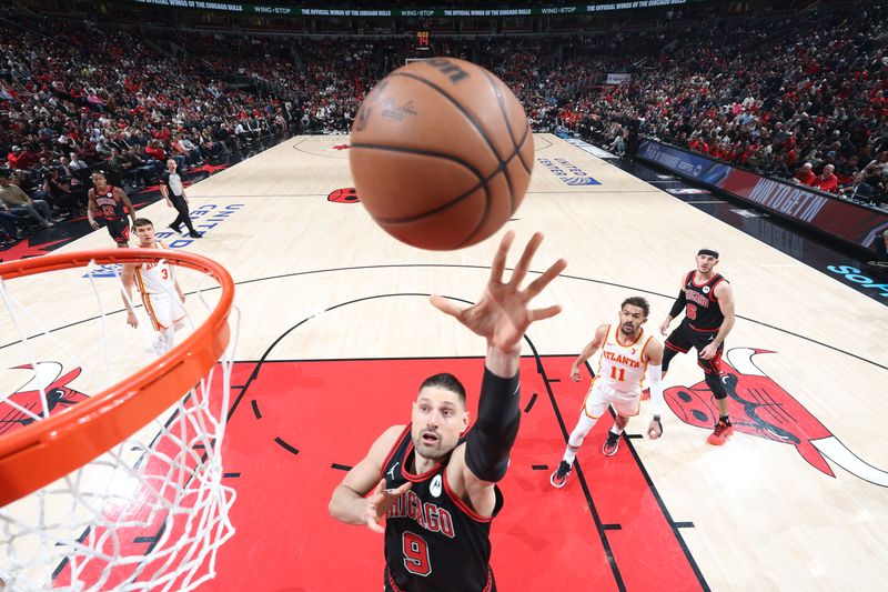 CHICAGO, IL - APRIL 17:  Nikola Vucevic #9 of the Chicago Bulls goes to the basket during the game during the 2024 Play-In Tournament  on April 17, 2024 at United Center in Chicago, Illinois. NOTE TO USER: User expressly acknowledges and agrees that, by downloading and or using this photograph, User is consenting to the terms and conditions of the Getty Images License Agreement. Mandatory Copyright Notice: Copyright 2024 NBAE (Photo by Jeff Haynes/NBAE via Getty Images)