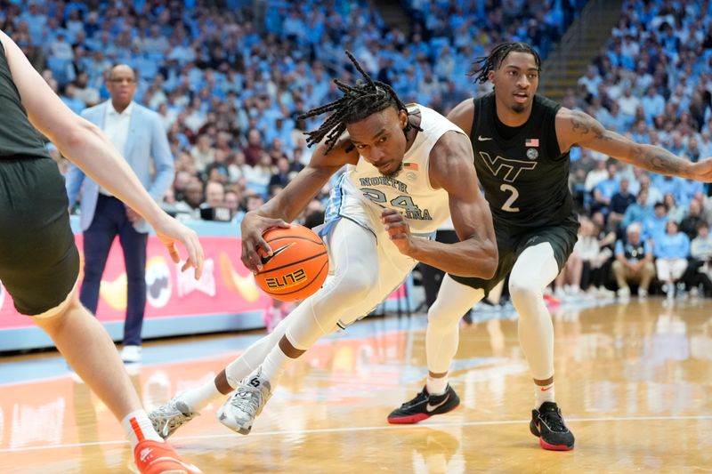 Feb 17, 2024; Chapel Hill, North Carolina, USA; North Carolina Tar Heels forward Jae'Lyn Withers (24) dribbles as Virginia Tech Hokies guard MJ Collins (2) defends in the second half at Dean E. Smith Center. Mandatory Credit: Bob Donnan-USA TODAY Sports