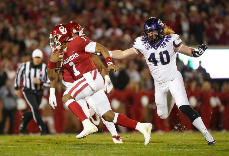 Nov 23, 2019; Norman, OK, USA; Oklahoma Sooners quarterback Jalen Hurts (1) runs past TCU Horned Frogs defensive end Parker Workman (40) during the first quarter at Gaylord Family - Oklahoma Memorial Stadium. Mandatory Credit: Kevin Jairaj-USA TODAY Sports