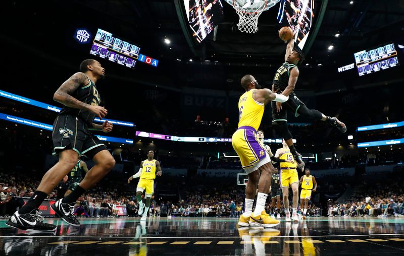 CHARLOTTE, NORTH CAROLINA - JANUARY 02: Dennis Smith Jr. #8 of the Charlotte Hornets attempts to dunk against LeBron James #6 of the Los Angeles Lakers during the second half of the game at Spectrum Center on January 02, 2023 in Charlotte, North Carolina. NOTE TO USER: User expressly acknowledges and agrees that, by downloading and or using this photograph, User is consenting to the terms and conditions of the Getty Images License Agreement. (Photo by Jared C. Tilton/Getty Images)