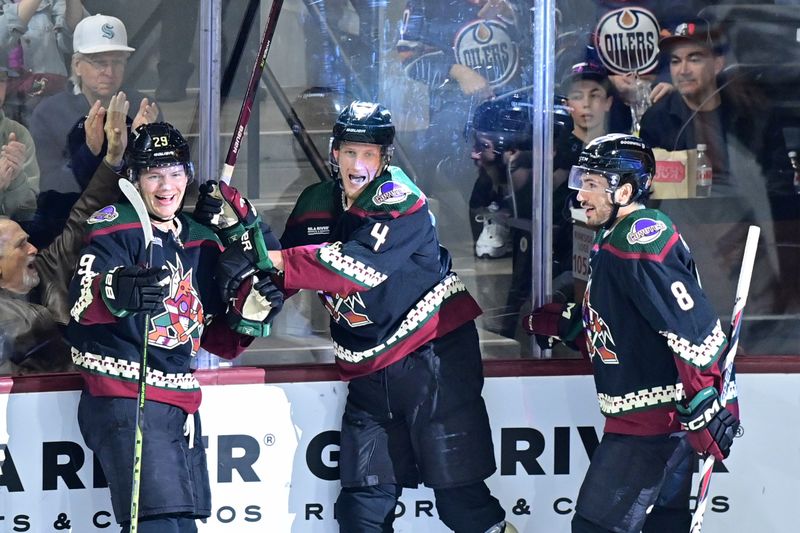 Mar 27, 2023; Tempe, Arizona, USA;  Arizona Coyotes center Barrett Hayton (29) celebrates with defenseman Juuso Valimaki (4) and center Nick Schmaltz (8) after scoring a goal in the third period against the Edmonton Oilers at Mullett Arena. Mandatory Credit: Matt Kartozian-USA TODAY Sports