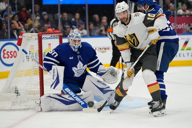 Nov 20, 2024; Toronto, Ontario, CAN; Vegas Golden Knights forward Nicolas Roy (10) tries to deflect a puck at Toronto Maple Leafs goaltender Joseph Woll (60) during the second period at Scotiabank Arena. Mandatory Credit: John E. Sokolowski-Imagn Images