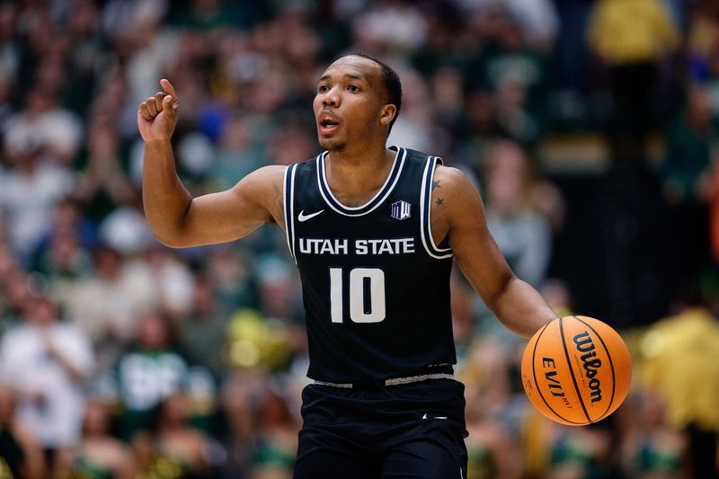 Feb 17, 2024; Fort Collins, Colorado, USA; Utah State Aggies guard Darius Brown II (10) gestures as he dribbles the ball up court in the first half against the Colorado State Rams at Moby Arena. Mandatory Credit: Isaiah J. Downing-USA TODAY Sports