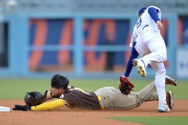 Apr 14, 2024; Los Angeles, California, USA; San Diego Padres shortstop Ha-Seong Kim (7)is tagged out by Los Angeles Dodgers second base Gavin Lux (9) on an attempted stolen base in the second inning at Dodger Stadium. Mandatory Credit: Jayne Kamin-Oncea-USA TODAY Sports