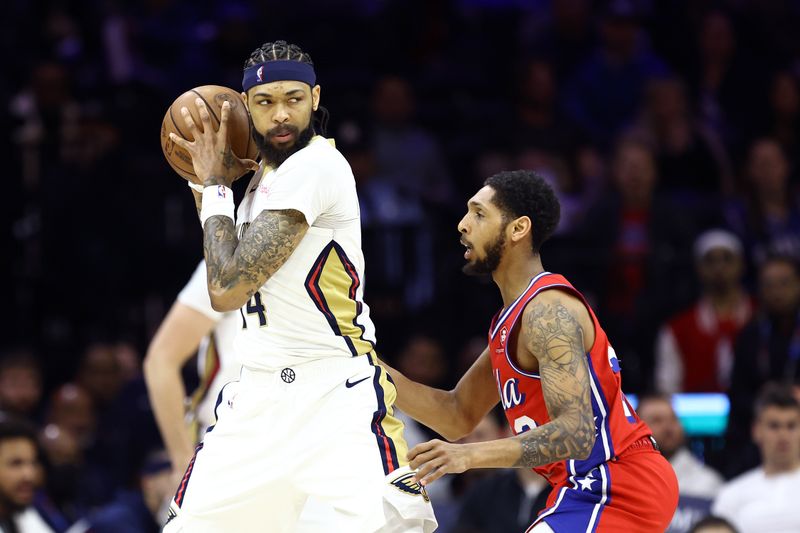 PHILADELPHIA, PENNSYLVANIA - MARCH 08: Brandon Ingram #14 of the New Orleans Pelicans is guarded by Cameron Payne #22 of the Philadelphia 76ers during the fourth quarter at the Wells Fargo Center on March 08, 2024 in Philadelphia, Pennsylvania. NOTE TO USER: User expressly acknowledges and agrees that, by downloading and or using this photograph, User is consenting to the terms and conditions of the Getty Images License Agreement.  (Photo by Tim Nwachukwu/Getty Images)