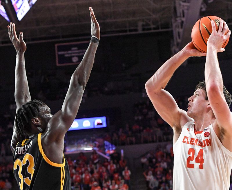 Feb 27, 2024; Clemson, South Carolina, USA; Clemson junior forward PJ Hall (24) shoots the ball near Pitt center Federiko Federiko (33) during the second half at Littlejohn Coliseum. Mandatory Credit: Ken Ruinard-USA TODAY Sports