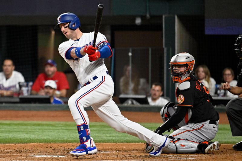 Oct 10, 2023; Arlington, Texas, USA; Texas Rangers catcher Mitch Garver (18) hits an RBI double in the second inning against the Baltimore Orioles during game three of the ALDS for the 2023 MLB playoffs at Globe Life Field. Mandatory Credit: Jerome Miron-USA TODAY Sports