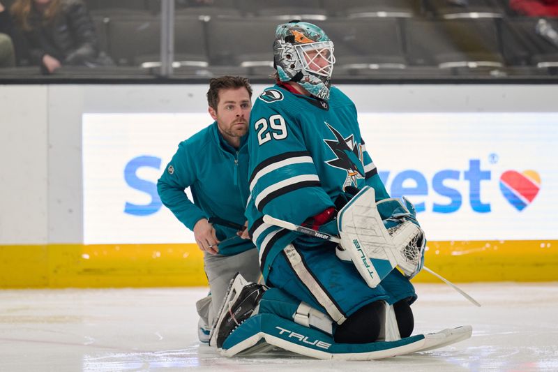 Dec 12, 2023; San Jose, California, USA; San Jose Sharks assistant equipment manager Jon Laughner repairs a skate blade for San Jose Sharks goaltender Mackenzie Blackwood (29) during a stoppage of play against the Winnipeg Jets in the third period at SAP Center at San Jose. Mandatory Credit: Robert Edwards-USA TODAY Sports