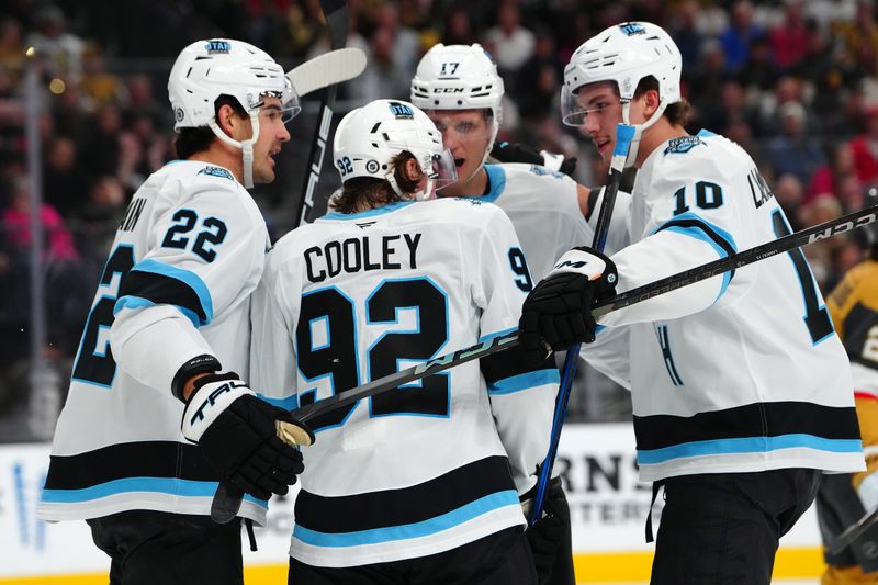 Nov 2, 2024; Las Vegas, Nevada, USA; Utah Hockey Club center Logan Cooley (92) celebrates with team mates after scoring a goal against the Vegas Golden Knights during the first period at T-Mobile Arena. Mandatory Credit: Stephen R. Sylvanie-Imagn Images