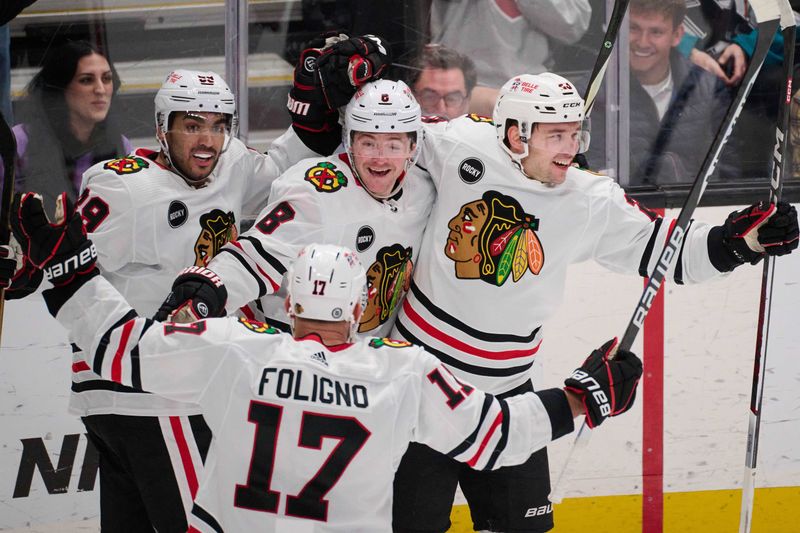 Mar 23, 2024; San Jose, California, USA; Chicago Blackhawks center Philipp Kurashev (23) celebrates with center Ryan Donato (8) center Andreas Athanasiou (89) and left wing Nick Foligno (17) after scoring the game-tying goal against the San Jose Sharks during the third period at SAP Center at San Jose. Mandatory Credit: Robert Edwards-USA TODAY Sports