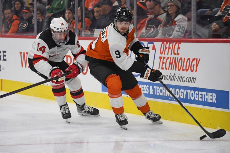 Jan 27, 2025; Philadelphia, Pennsylvania, USA; Philadelphia Flyers defenseman Jamie Drysdale (9) carries the ouck against New Jersey Devils right wing Nathan Bastian (14) during the second period at Wells Fargo Center. Mandatory Credit: Eric Hartline-Imagn Images