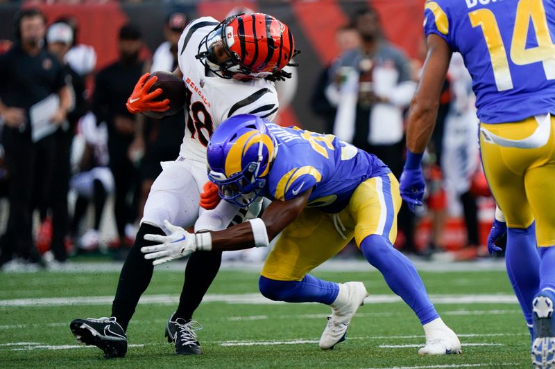 Los Angeles Rams cornerback Grant Haley (36) hits Cincinnati Bengals wide receiver Kwamie Lassiter II (18) during the first half of a preseason NFL football game in Cincinnati, Saturday, Aug. 27, 2022. (AP Photo/Joshua A. Bickel)