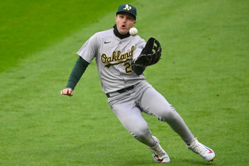 Apr 20, 2024; Cleveland, Ohio, USA; Oakland Athletics right fielder Tyler Nevin (26) makes a sliding catch in the fifth inning against the Cleveland Guardians at Progressive Field. Mandatory Credit: David Richard-USA TODAY Sports