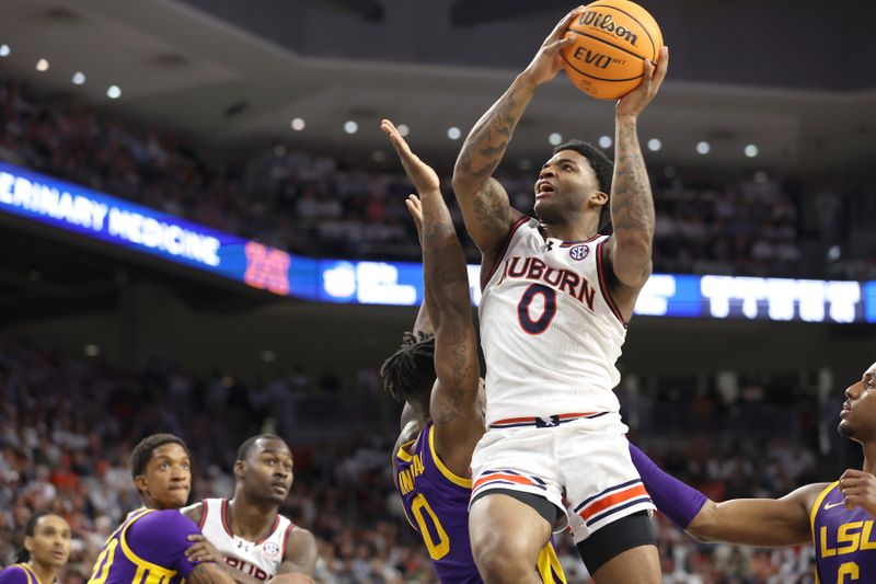 Jan 13, 2024; Auburn, Alabama, USA; Auburn Tigers guard K.D. Johnson (0) goes for a shot against the LSU Tigers during the second half at Neville Arena. Mandatory Credit: John Reed-USA TODAY Sports