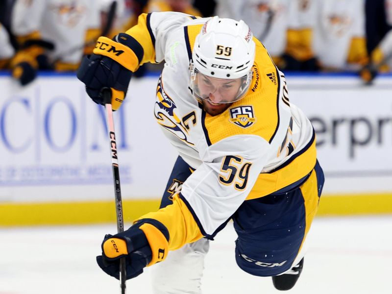 Dec 3, 2023; Buffalo, New York, USA;  Nashville Predators defenseman Roman Josi (59) takes a shot on goal during the first period against the Buffalo Sabres at KeyBank Center. Mandatory Credit: Timothy T. Ludwig-USA TODAY Sports