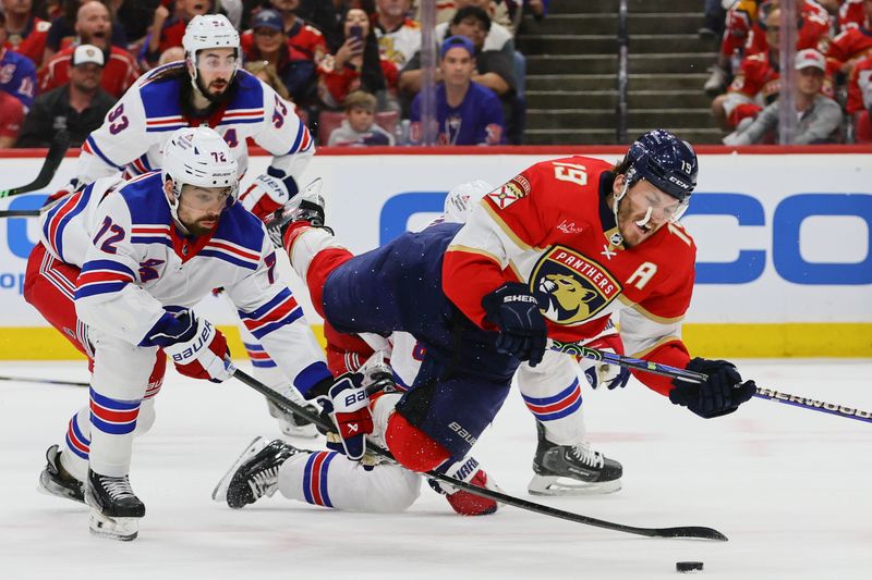 May 26, 2024; Sunrise, Florida, USA; Florida Panthers left wing Matthew Tkachuk (19) battles for the puck against New York Rangers center Filip Chytil (72) during the third period in game three of the Eastern Conference Final of the 2024 Stanley Cup Playoffs at Amerant Bank Arena. Mandatory Credit: Sam Navarro-USA TODAY Sports