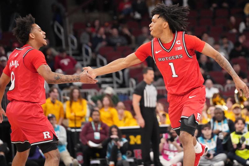 Mar 11, 2026; Chicago, IL, USA; Rutgers Scarlet Knights guard Jamichael Davis (1) is greeted by Rutgers Scarlet Knights guard Tariq Francis (0) after making a three point basket against the Minnesota Golden Gophers during the first half at United Center. Mandatory Credit: David Banks-Imagn Images