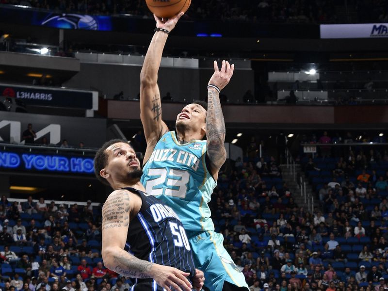 ORLANDO, FL - MARCH 19: Tre Mann #23 of the Charlotte Hornets shoots the ball during the game against the Orlando Magic on March 19, 2024 at the Kia Center in Orlando, Florida. NOTE TO USER: User expressly acknowledges and agrees that, by downloading and or using this photograph, User is consenting to the terms and conditions of the Getty Images License Agreement. Mandatory Copyright Notice: Copyright 2024 NBAE (Photo by Fernando Medina/NBAE via Getty Images)