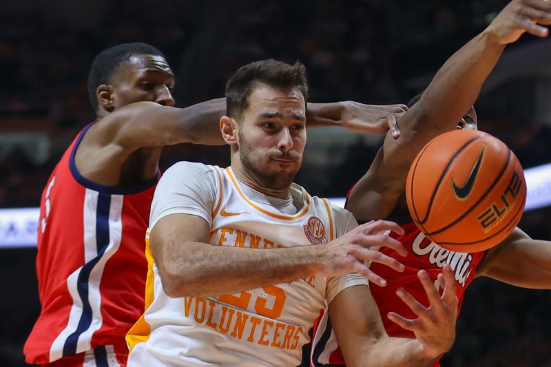 Jan 6, 2024; Knoxville, Tennessee, USA; Tennessee Volunteers guard Santiago Vescovi (25) fights for a rebound against the Mississippi Rebels during the first half at Thompson-Boling Arena at Food City Center. Mandatory Credit: Randy Sartin-USA TODAY Sports