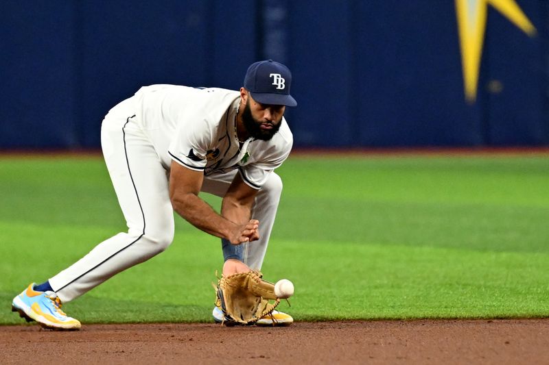 May 29, 2024; St. Petersburg, Florida, USA;  Tampa Bay Rays shortstop Amed Rosario (10) fields a ground ball in the first inning against the Oakland Athletics at Tropicana Field. Mandatory Credit: Jonathan Dyer-USA TODAY Sports