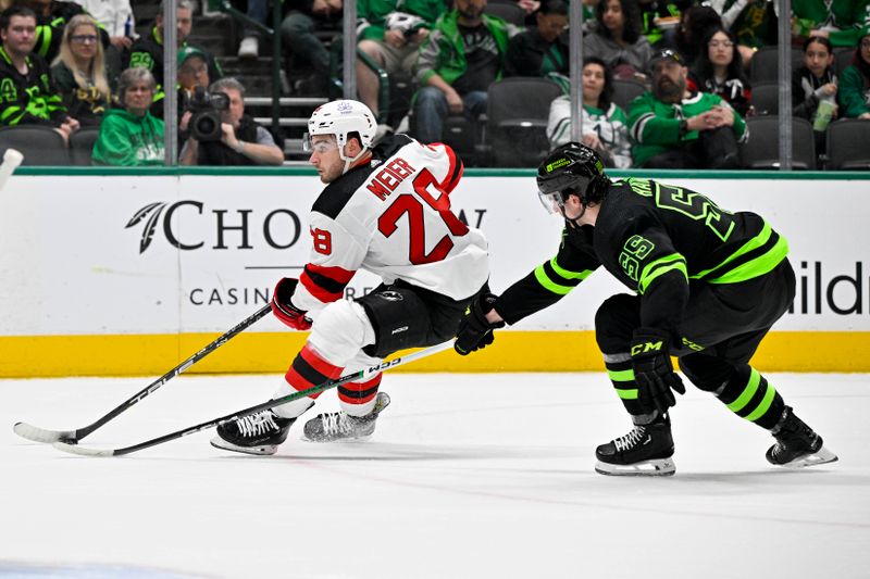 Mar 14, 2024; Dallas, Texas, USA; New Jersey Devils right wing Timo Meier (28) skates with the puck past Dallas Stars defenseman Thomas Harley (55) during the first period at the American Airlines Center. Mandatory Credit: Jerome Miron-USA TODAY Sports