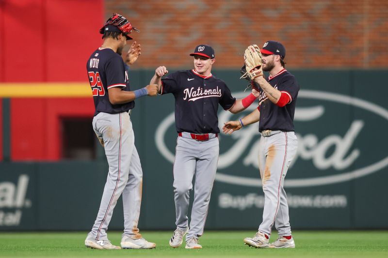 May 14, 2025; Atlanta, Georgia, USA; Washington Nationals left fielder James Wood (29) and center fielder Jacob Young (30) and right fielder Dylan Crews (3) celebrate after a victory over the Atlanta Braves at Truist Park. Mandatory Credit: Brett Davis-Imagn Images
