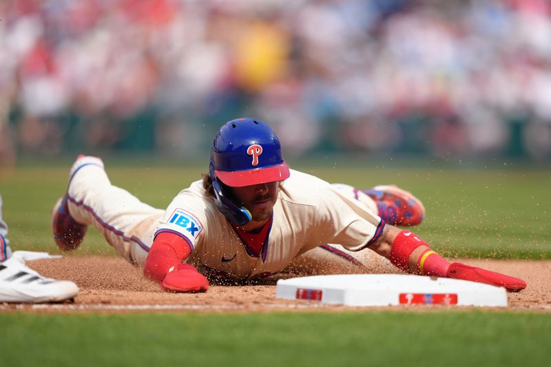 Apr 19, 2025; Philadelphia, Pennsylvania, USA; Philadelphia Phillies infielder Bryson Stott (5) slides into third against the Miami Marlins in the seventh inning at Citizens Bank Park. Mandatory Credit: Kyle Ross-Imagn Images