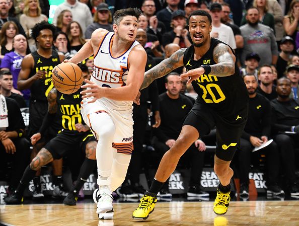 SALT LAKE CITY, UTAH - NOVEMBER 19: Grayson Allen #8 of the Phoenix Suns drives past John Collins #20 of the Utah Jazz during the second half of a game at Delta Center on November 19, 2023 in Salt Lake City, Utah. NOTE TO USER: User expressly acknowledges and agrees that, by downloading and or using this photograph, User is consenting to the terms and conditions of the Getty Images License Agreement. (Photo by Alex Goodlett/Getty Images)