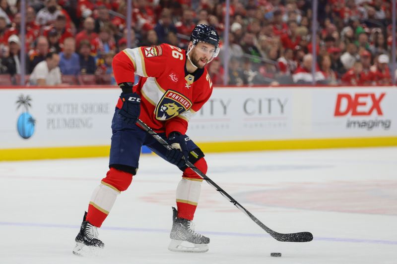 Oct 8, 2024; Sunrise, Florida, USA; Florida Panthers defenseman Uvis Balinskis (26) moves the puck against the Boston Bruins during the second period at Amerant Bank Arena. Mandatory Credit: Sam Navarro-Imagn Images