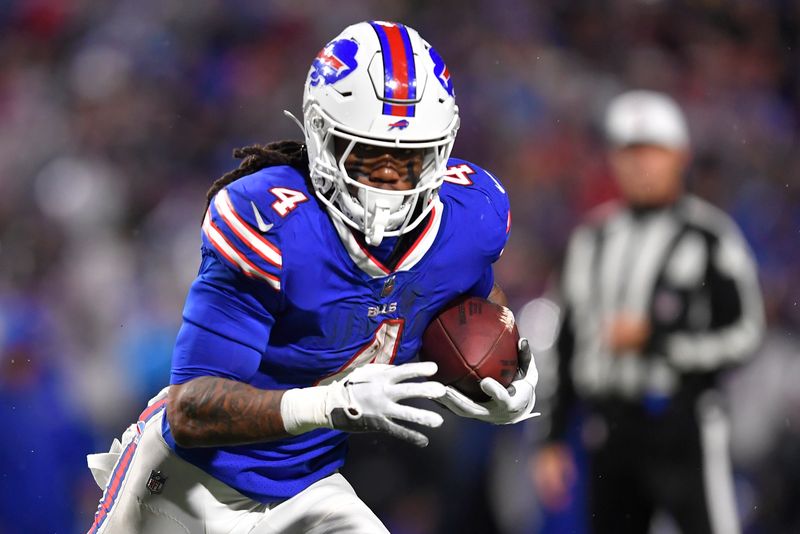 Buffalo Bills running back James Cook (4) carries the ball against the Dallas Cowboys during the second half of an NFL football game, Sunday, Dec. 17, 2023, in Orchard Park, N.Y. (AP Photo/Adrian Kraus)