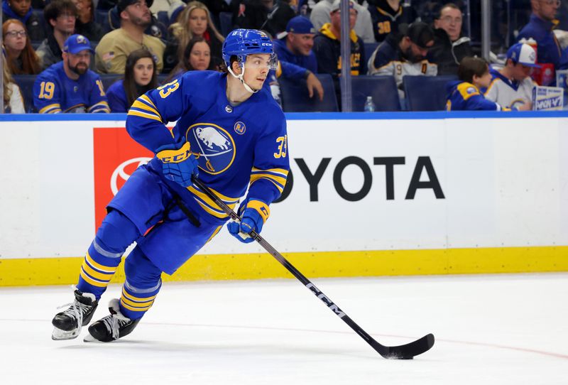 Dec 30, 2023; Buffalo, New York, USA;  Buffalo Sabres defenseman Ryan Johnson (33) skates with the puck during the third period against the Columbus Blue Jackets at KeyBank Center. Mandatory Credit: Timothy T. Ludwig-USA TODAY Sports